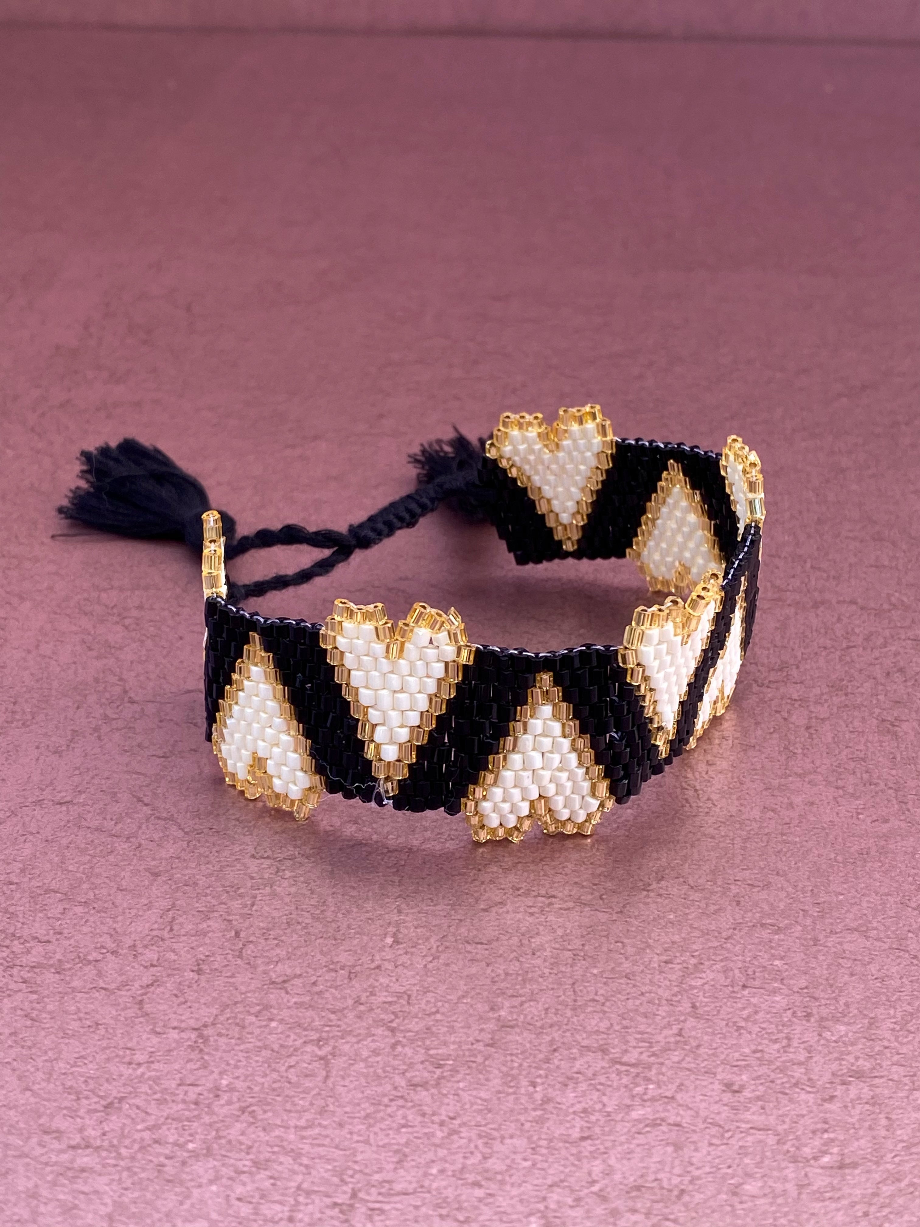 Beaded Bracelet Black with White Hearts Trimmed in Gold Tassel Closure